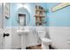 Charming powder room with a pedestal sink, decorative shelving, and a modern toilet at 1831 Devonridge Dr, Fuquay Varina, NC 27526