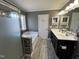 Full bathroom with shower, soaking tub with tile surround, double vanity, and wood-look flooring at 1831 Devonridge Dr, Fuquay Varina, NC 27526