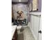 Charming bathroom with whimsical shower curtain, decorative accents, and white wainscoting at 1831 Devonridge Dr, Fuquay Varina, NC 27526