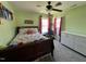 Cozy bedroom with floral bedding, light green walls, carpet flooring, and a bright window at 1831 Devonridge Dr, Fuquay Varina, NC 27526