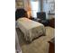 Cozy bedroom featuring neutral tones, a comfortable bed, and a relaxing armchair at 1831 Devonridge Dr, Fuquay Varina, NC 27526