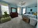 A colorful bedroom featuring blue walls, patterned curtains, and a comfy chair at 1831 Devonridge Dr, Fuquay Varina, NC 27526