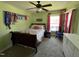 Bright bedroom featuring a floral bedspread, ceiling fan, and decorative horse ribbons at 1831 Devonridge Dr, Fuquay Varina, NC 27526