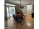 Charming dining room with hardwood floors, a round table, and access to the backyard through sliding glass doors at 1831 Devonridge Dr, Fuquay Varina, NC 27526