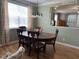 Bright dining area with a wood dining table and six chairs, and large window allowing natural light at 1831 Devonridge Dr, Fuquay Varina, NC 27526