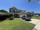 Two-story home with stone accents, attached garage, and driveway with car parked in front on a well-manicured lawn at 1831 Devonridge Dr, Fuquay Varina, NC 27526