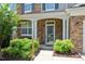 Inviting front porch with stone accents, decorative shrubs, and a clear view of the entrance at 1831 Devonridge Dr, Fuquay Varina, NC 27526