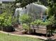 A well-organized garden plot with multiple raised beds, potting soil and protective netting at 1831 Devonridge Dr, Fuquay Varina, NC 27526