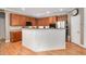Kitchen featuring wood cabinets, stainless steel appliances, an island and laminate floors at 1831 Devonridge Dr, Fuquay Varina, NC 27526