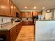 Spacious kitchen features beautiful wood cabinets, granite countertops, stainless steel appliances, and a convenient breakfast bar at 1831 Devonridge Dr, Fuquay Varina, NC 27526