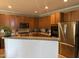 Bright kitchen boasts stainless steel appliances, wood cabinets, granite countertops, and an open layout for entertaining at 1831 Devonridge Dr, Fuquay Varina, NC 27526