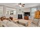 Cozy living room boasts a fireplace, large TV, and comfortable seating arrangements at 1831 Devonridge Dr, Fuquay Varina, NC 27526