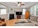 Comfortable living room featuring a fireplace, TV, and ample seating with natural lighting at 1831 Devonridge Dr, Fuquay Varina, NC 27526