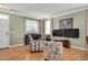 Bright living room with wood flooring, large windows, and stylish furnishings at 1831 Devonridge Dr, Fuquay Varina, NC 27526