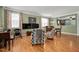 Bright living room with wood flooring, large windows, and stylish furnishings at 1831 Devonridge Dr, Fuquay Varina, NC 27526