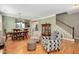 A comfortable living room offers a dining room view, hardwood floors, and cozy armchairs at 1831 Devonridge Dr, Fuquay Varina, NC 27526