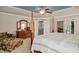 Main bedroom features a four post bed, dresser, and access to bathroom and closet at 1831 Devonridge Dr, Fuquay Varina, NC 27526