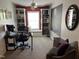 Inviting home office featuring built-in bookshelves, a cozy window seat, and ample workspace for productivity at 1831 Devonridge Dr, Fuquay Varina, NC 27526