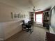Bright home office with built-in bookshelves, a window seat, neutral walls, and ceiling fan at 1831 Devonridge Dr, Fuquay Varina, NC 27526