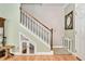 Unique staircase design features a hidden pet space and classic wooden accents at 1831 Devonridge Dr, Fuquay Varina, NC 27526