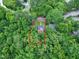 Aerial view of the property, bordered in red, surrounded by lush greenery and mature trees at 1907 Bivins St, Durham, NC 27707
