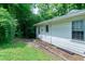 View of the back of the home with access to the yard; lush greenery with bamboo accents at 1907 Bivins St, Durham, NC 27707