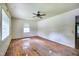 Spacious bedroom with hardwood floors, a ceiling fan, and lots of natural light from large windows at 1907 Bivins St, Durham, NC 27707