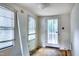 Bedroom with hardwood floors, natural light, and a door leading to the porch at 1907 Bivins St, Durham, NC 27707