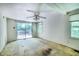 Bedroom features a ceiling fan, window, and sliding glass doors to a backyard deck at 1907 Bivins St, Durham, NC 27707