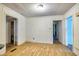 Light-filled open space with hardwood floors and white paneled walls and access to two other rooms at 1907 Bivins St, Durham, NC 27707