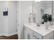 Bathroom vanity featuring white cabinets, a large mirror, and modern fixtures at 199 High Woods Rdg, Chapel Hill, NC 27517