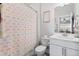 Bright bathroom features a toilet, shower with rainbow-themed curtain, and single vanity at 199 High Woods Rdg, Chapel Hill, NC 27517