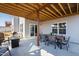 Covered patio with a dining table set and a fire pit sitting area perfect for outdoor relaxation at 199 High Woods Rdg, Chapel Hill, NC 27517