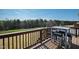 Outdoor deck area featuring a table and chairs, perfect for enjoying the scenic view and fresh air at 199 High Woods Rdg, Chapel Hill, NC 27517
