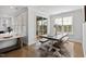 Bright dining area featuring hardwood floors, a large table with bench seating and sliding door access to the outdoors at 199 High Woods Rdg, Chapel Hill, NC 27517