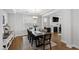 Elegant dining room with a large wooden table, modern chandelier, and a fireplace in the background at 199 High Woods Rdg, Chapel Hill, NC 27517