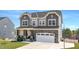 Charming two-story home with stone accents, covered porch, and attached two car garage at 199 High Woods Rdg, Chapel Hill, NC 27517