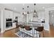 Modern kitchen featuring white cabinets, stainless steel appliances, and a large island with seating at 199 High Woods Rdg, Chapel Hill, NC 27517