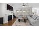 Inviting living room features a fireplace, large windows, a ceiling fan, and cozy furnishings at 199 High Woods Rdg, Chapel Hill, NC 27517