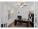 Functional home office with natural light, built-in shelving, and a ceiling fan at 199 High Woods Rdg, Chapel Hill, NC 27517