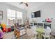 Spacious playroom featuring large window, carpeting, a ceiling fan, a television and lots of storage at 199 High Woods Rdg, Chapel Hill, NC 27517