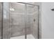 Walk-in shower featuring glass doors, neutral tiling, and modern fixtures at 199 High Woods Rdg, Chapel Hill, NC 27517