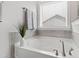 Soaking tub with a window view and modern fixtures at 199 High Woods Rdg, Chapel Hill, NC 27517