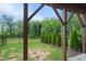 Covered patio overlooking a fenced backyard with mature trees and landscaping at 2055 Eva Pearl Dr, Apex, NC 27502