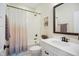 Bathroom with tiled shower and tub, framed mirror, and neutral-toned shower curtain at 2055 Eva Pearl Dr, Apex, NC 27502