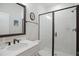 Modern bathroom with glass-enclosed shower, white subway tiles, and bronze fixtures at 2055 Eva Pearl Dr, Apex, NC 27502