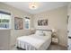 Cozy bedroom features a queen bed, neutral decor and a bright window at 2055 Eva Pearl Dr, Apex, NC 27502