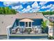 Inviting deck with modern furniture, potted plants and an umbrella for shade at 2055 Eva Pearl Dr, Apex, NC 27502