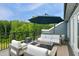 Relaxing deck with modern outdoor seating, fire pit, and lush tree views at 2055 Eva Pearl Dr, Apex, NC 27502