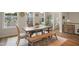 Charming dining room with a rustic wooden table, bench seating, and views of the neighborhood at 2055 Eva Pearl Dr, Apex, NC 27502